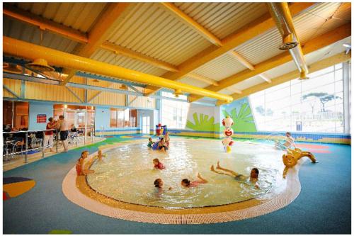 a group of people swimming in a swimming pool at Hoburne Naish CS129 in New Milton