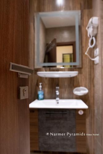 a bathroom with a sink and a mirror at Narmer Pyramids View in Cairo