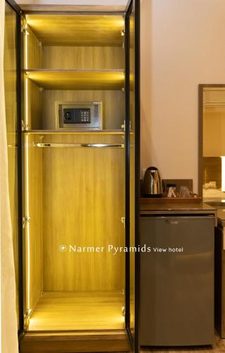a gold refrigerator with a microwave inside of it at Narmer Pyramids View in Cairo