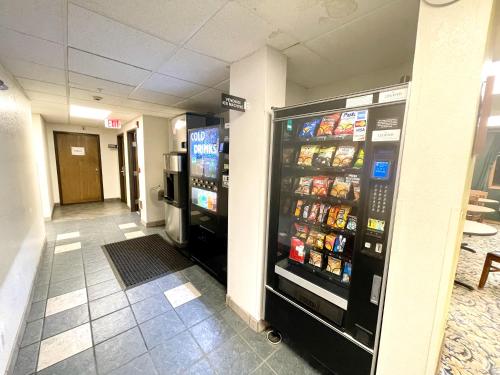 a convenience store with two soda machines in a hallway at SureStay by Best Western Prince Frederick in Prince Frederick