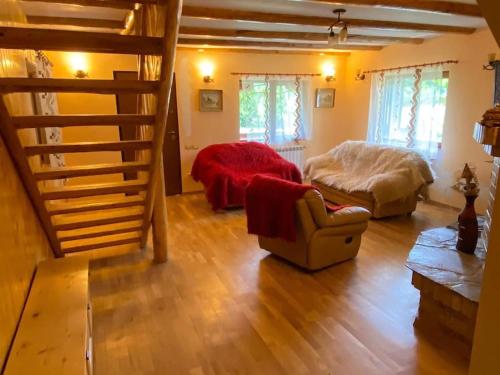 a living room with a bed and a staircase at Amazing villa in the mountains with Jacuzzi in Vistisoara