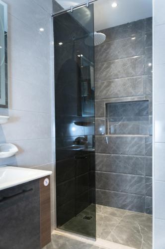 a shower with a glass door in a bathroom at Narmer Pyramids View in Cairo