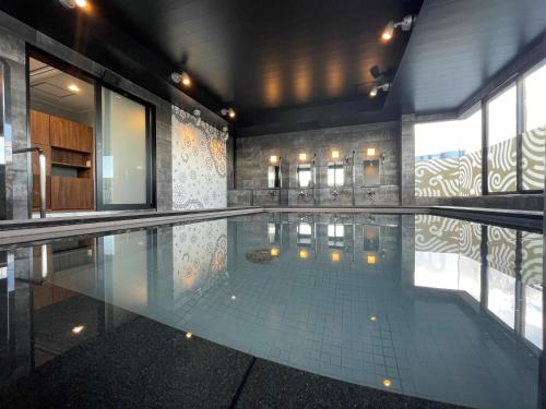 a large swimming pool in a building at Kotohira Park Hotel in Kotohira