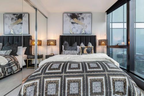 a bedroom with a large bed and glass walls at Australia 108 Palazzo Glam Luxury Apt Near Crown in Melbourne