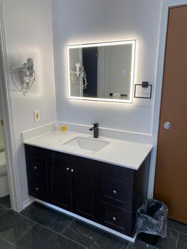 a bathroom with a sink and a mirror at Bavarian Inn in Bruce Mines