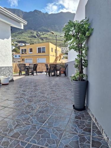 a patio with chairs and a plant in a pot at Hierro in Frontera
