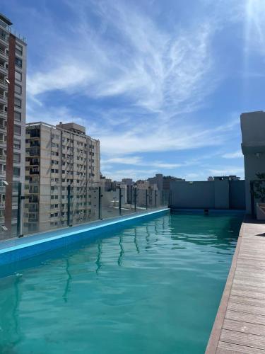 a swimming pool on the roof of a building at Palermo Apartamento Buenos Aires in Buenos Aires