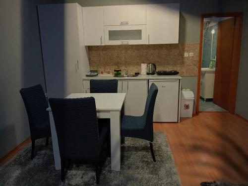 a kitchen with a table and chairs in a room at Apartmani Lazaro in Višegrad