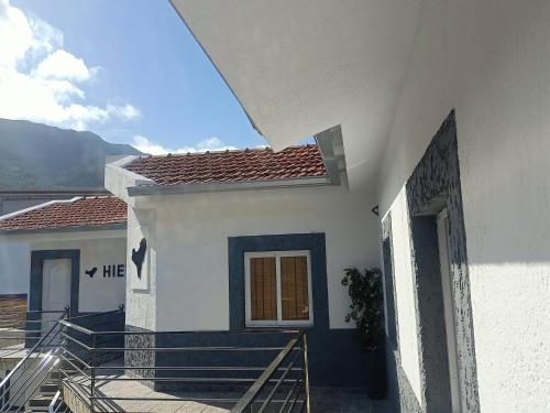 a white house with a staircase leading up to it at Hierro in Frontera