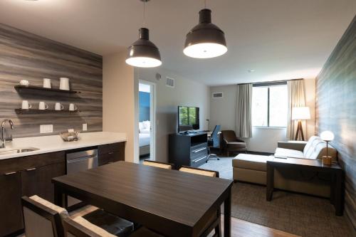 una cucina e un soggiorno con tavolo e divano di Residence Inn by Marriott Arvada Denver West ad Arvada