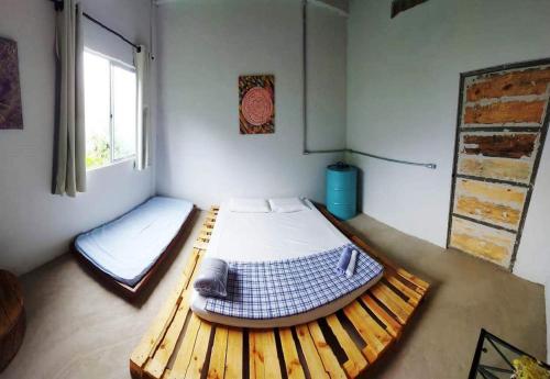 a room with two beds and a window at Pousada Vila da Serra - Quarto Cantinho do Sossego in Nova Lima