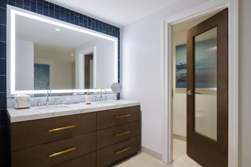 a bathroom with a sink and a large mirror at The Westin St Thomas Beach Resort & Spa in Frydendal