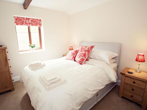 a bedroom with a bed with white sheets and a window at 1 bed in Crickhowell 42953 in Llangattock