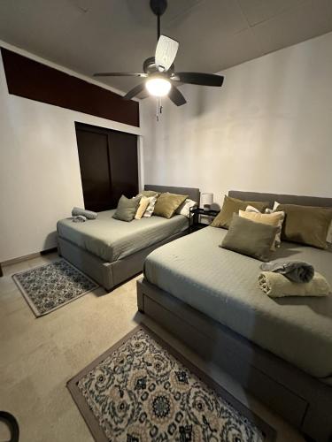 a bedroom with two beds and a ceiling fan at 176 Calle Perez (Apt 1A) in San Juan