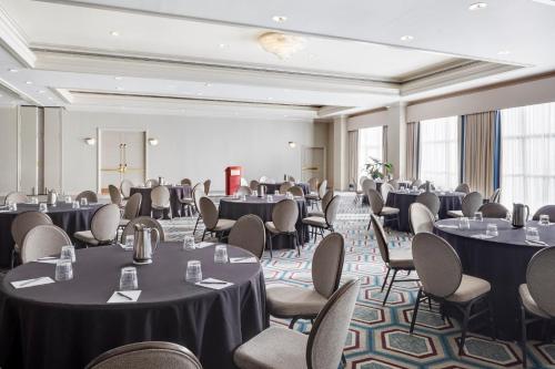 a banquet room with tables and chairs in a building at Crowne Plaza New Orleans French Qtr - Astor by IHG in New Orleans