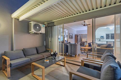 a living room with a couch and a table at Ocean Villa in Durban