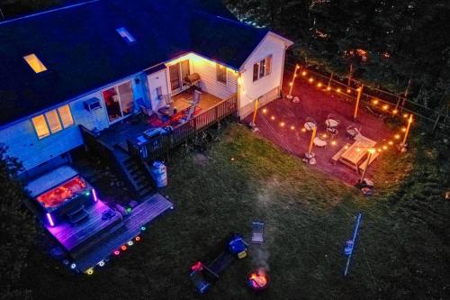 an aerial view of a house with lights on it at Zen Den - Pocono LakeFront with Hot Tub ! in Pocono Summit