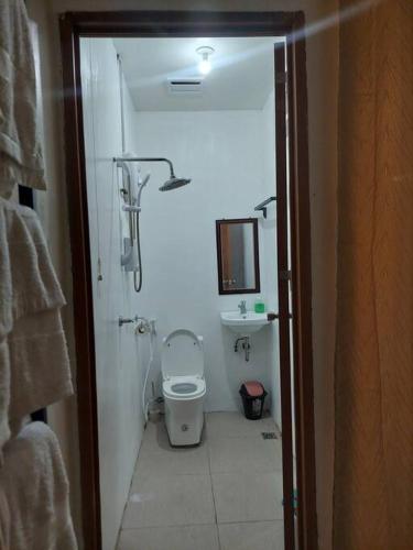 a small bathroom with a toilet and a shower at YB Rooftop Residence in General Santos