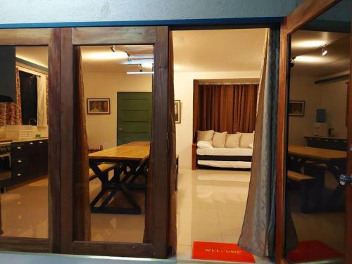a room with a table and a bedroom with a bed at YB Rooftop Residence in General Santos