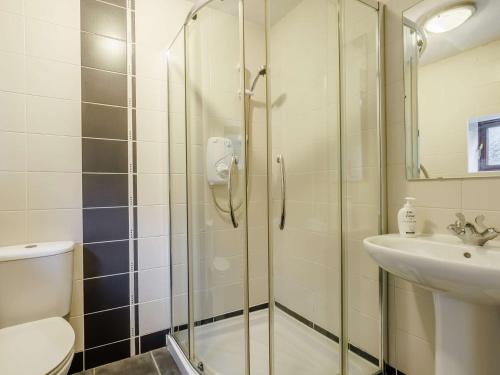 a bathroom with a shower and a toilet and a sink at 1 Bed in Glossop 52415 in Glossop