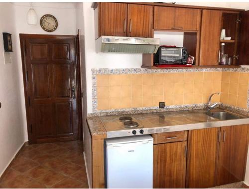 a kitchen with a sink and a stove top oven at Mirador Golf Cabo Negro in Cabo Negro