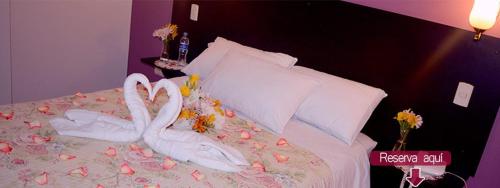 two swans made out of flowers on a bed at CASA REAL HOTEL in Tacna