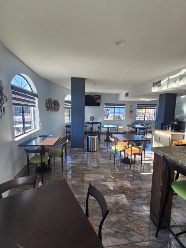 a restaurant with tables and chairs in a room at Days Inn & Suites by Wyndham Tucson/Marana in Tucson
