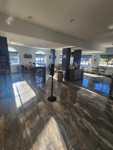 a large room with a lobby with tables and chairs at Days Inn & Suites by Wyndham Tucson/Marana in Tucson