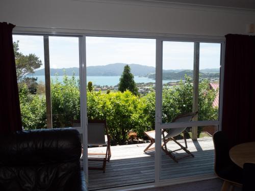 a living room with a large sliding glass door at Fun in the Sun in Cable Bay