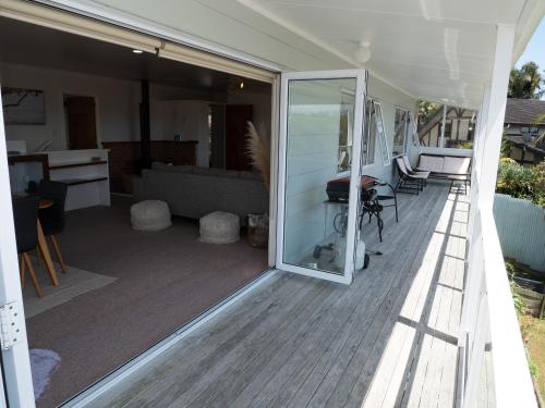 a sliding glass door on a porch of a house at Fun in the Sun in Cable Bay