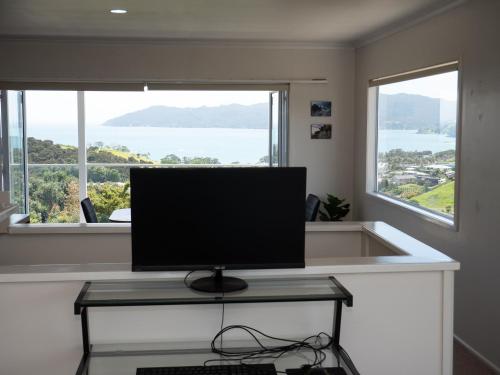 a computer monitor sitting on a desk in front of a window at Fun in the Sun in Cable Bay