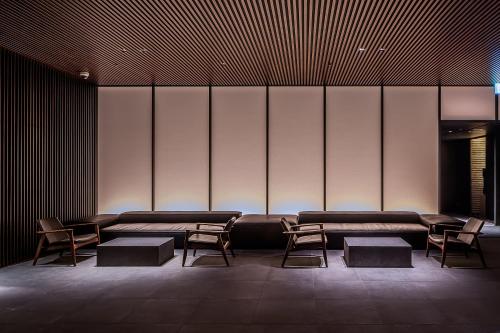 a waiting room with couches and tables and chairs at MUWA NISEKO in Kutchan