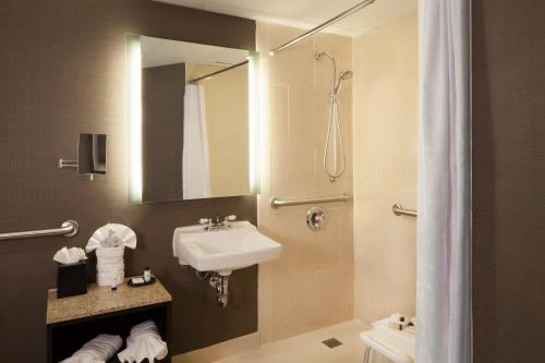 a bathroom with a sink and a shower at Sheraton Bucks County Langhorne in Langhorne