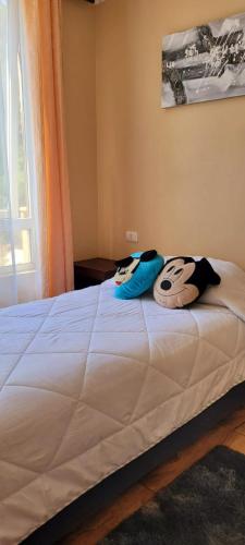 a bed with two pillows sitting on top of it at Playa Tomé Chile in Tomé