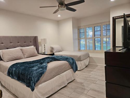 a bedroom with two beds and a ceiling fan at A Few Steps To Heated Pool, Tennis, Bike Trail in Scottsdale