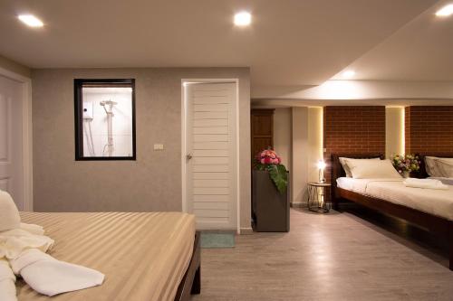 a hotel room with two beds and a window at Gate78 Hostel Maephim Beach in Mae Pim