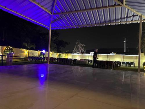 a person walking under a tent at night at OYO The Mount View in Jamshedpur