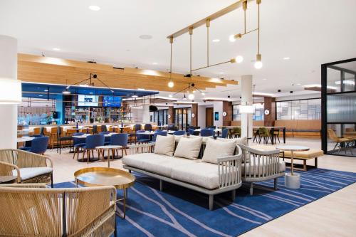 a lobby with couches and tables and a restaurant at Sheraton Chapel Hill in Chapel Hill
