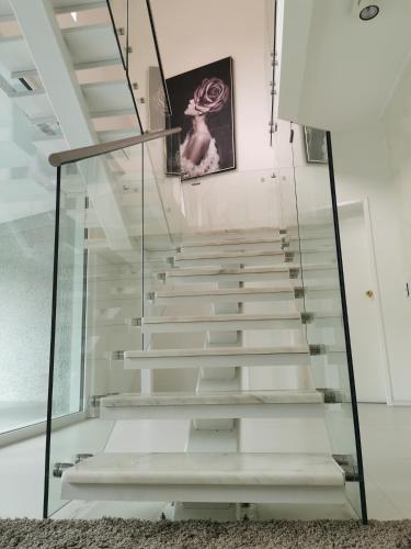 a glass staircase in a house at Luxury Harbour view in Dunedin