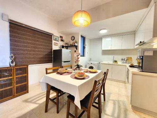 a kitchen with a table and chairs in a room at Loft Suite Central City 2BR JB CIQ 7Pax in Johor Bahru