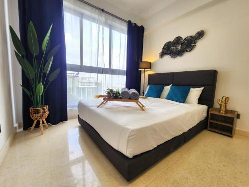 a bedroom with a large bed and a large window at Loft Suite JB Town near CIQ 7Pax in Johor Bahru