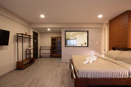a bedroom with a bed with a stuffed animal on it at Gate78 Hostel Maephim Beach in Mae Pim