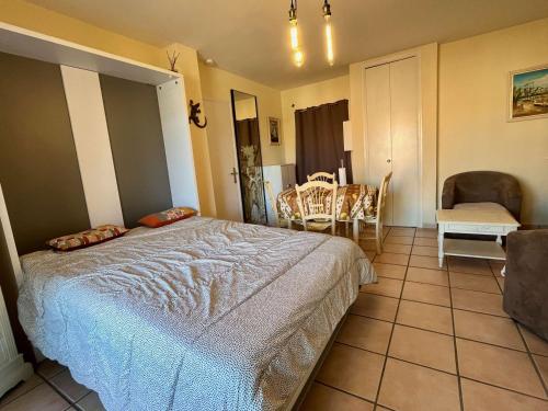 une chambre avec un lit, une table et des chaises dans l'établissement Appartement Climatisé Proche Plage et Commerces - 2 Pièces, 4 Pers, Parking Privé, Animaux Acceptés - FR-1-226B-177, à Cavalaire-sur-Mer