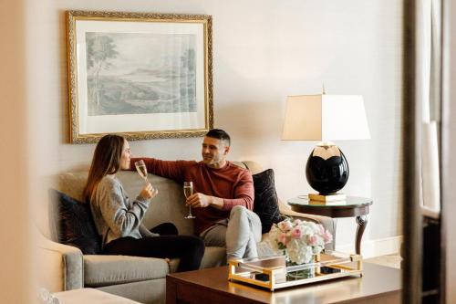 a man and woman sitting on a couch in a living room at Omni Shoreham Hotel in Washington