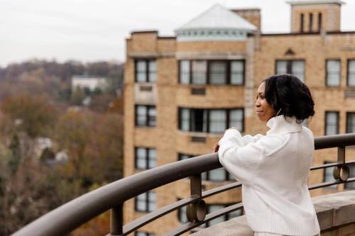 a woman standing on a balcony in front of a building at Omni Shoreham Hotel in Washington