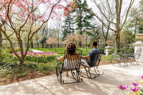 a man and woman sitting in chairs in a park at Omni Shoreham Hotel in Washington