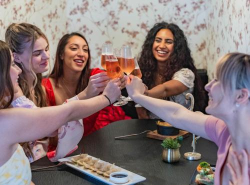 a group of women sitting around a table with glasses of beer at voco Niagara Falls - The Cadence by IHG in Niagara Falls