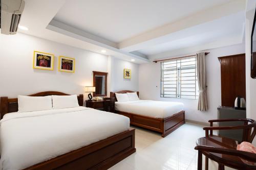Ένα ή περισσότερα κρεβάτια σε δωμάτιο στο Hoang Hoang Hotel (Bloom 3)