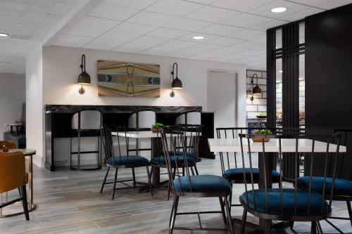 a room with chairs and a table and a kitchen at Des Moines Marriott Downtown in Des Moines