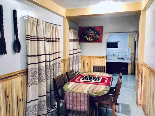 a kitchen with a table and chairs in a room at Baguio Exotic Vacation House in Baguio